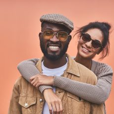 Positive beautiful nice woman expressing joy while embracing her boyfriend